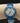 Reloj Marca Tempus para dama, color azul metalizado, taquimetro, hora militar.
